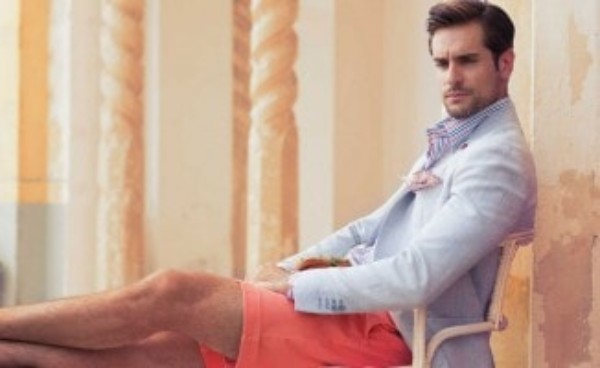 Men's light blue suit, checked blue shirt with coral shorts for casual look