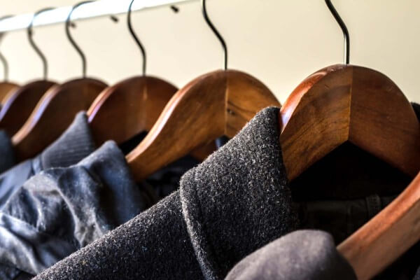 Winter coats are tug in hangers on a row, how to Store Clothing and Linens