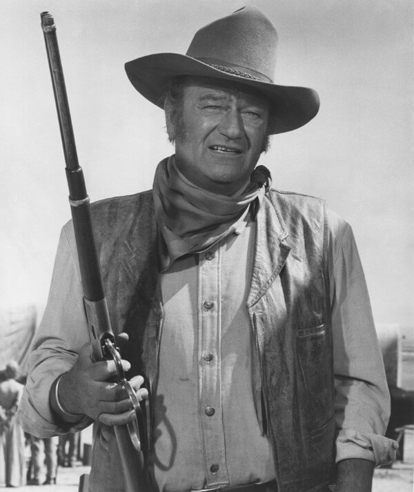 Actor John Wayne in a leather vest at rootin tootin cowboy shooting