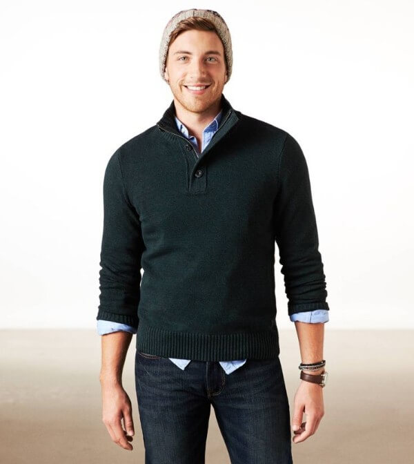 Men's green pullover shirt with blue jeans and cap combination for winter season