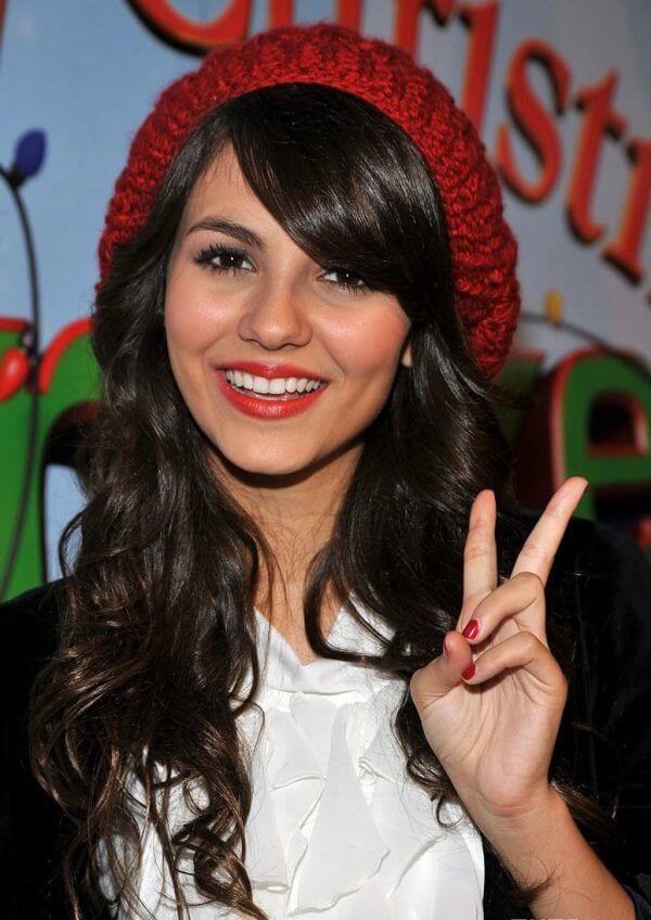 Victoria Justice red slouchy beanie with curly hair for winter season
