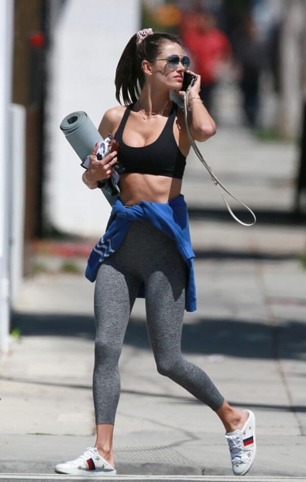 Alessandra Ambrosio in black sports bra, grey tights and white shoes 