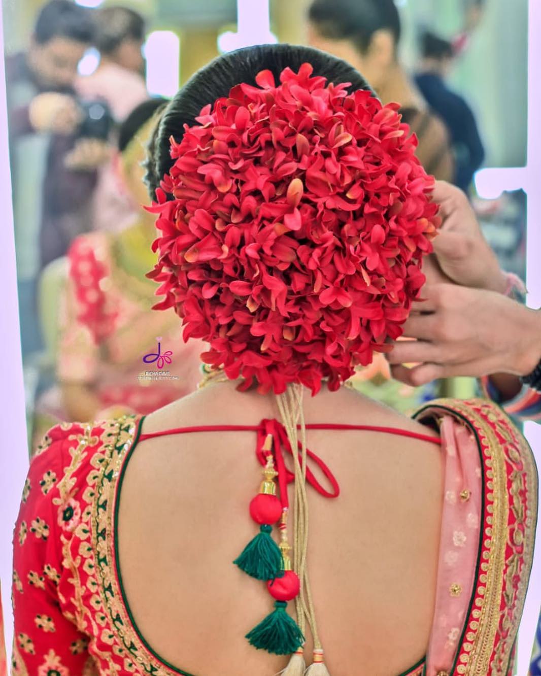 Red floral hairstyle: Bridal Bun Hairstyles with Flower Jewellery