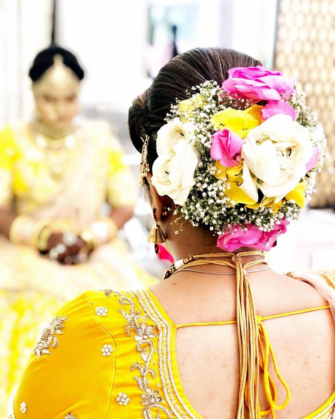  Multicoloured floral bun: Bridal Bun Hairstyles with Flower Jewellery