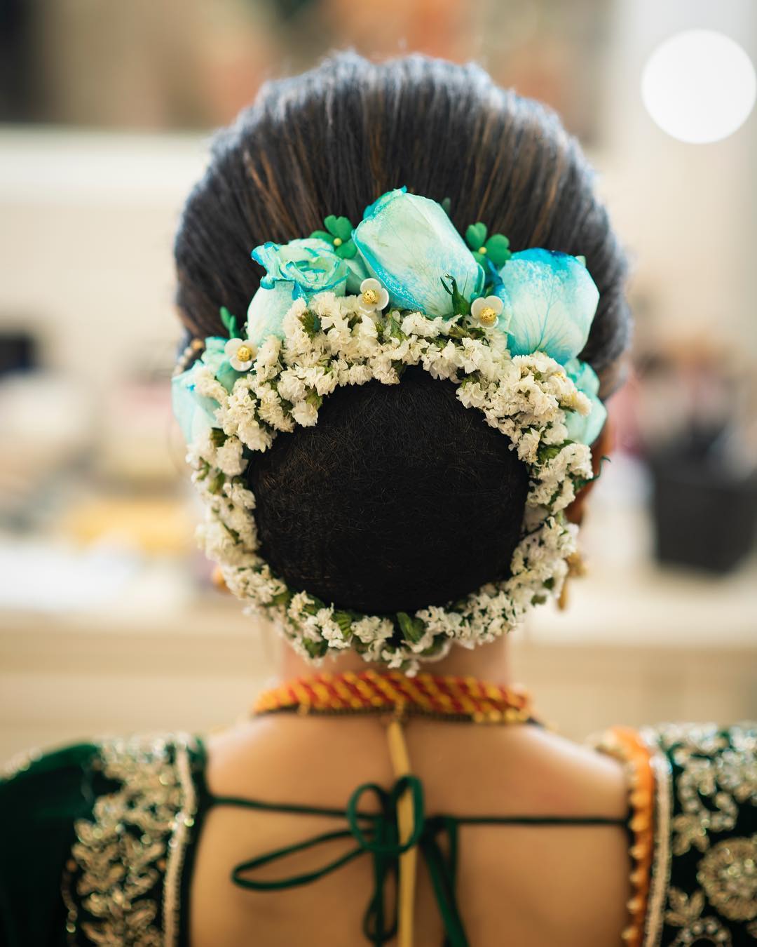 Pastel blue charm: Floral Bun Hairstyles for Brides this Wedding Season