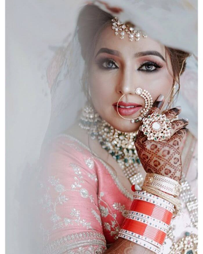A nath with one side covered with intricate details Latest Bridal Nath Designs for Traditional Indian Wedding