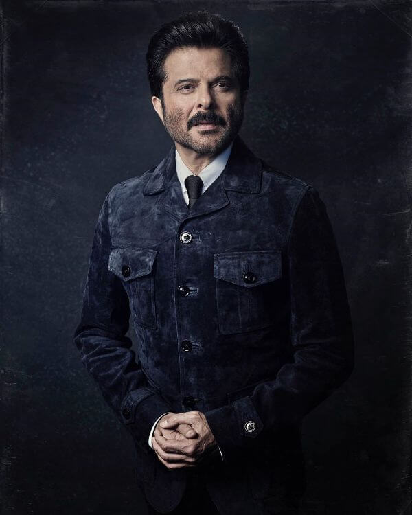 Anil Kapoor dark cords button-down jacket with a tie and black pant