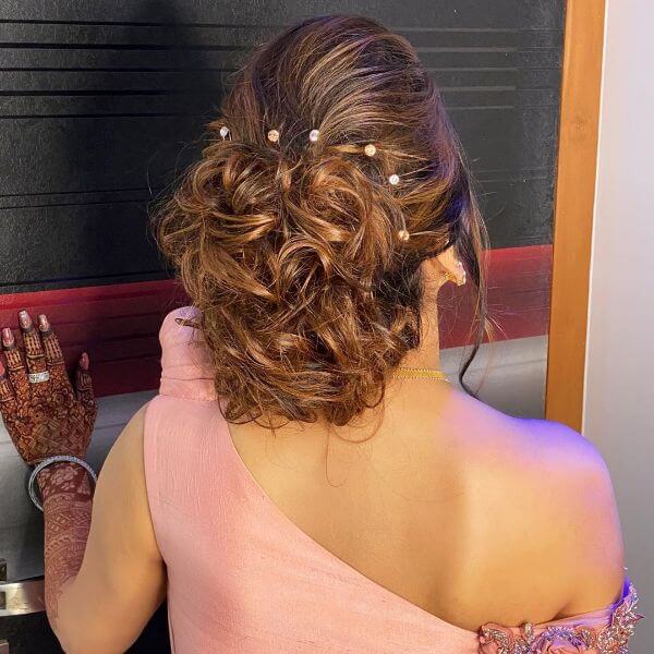 Messy loose bun with white head accessories for bride or bridesmaid