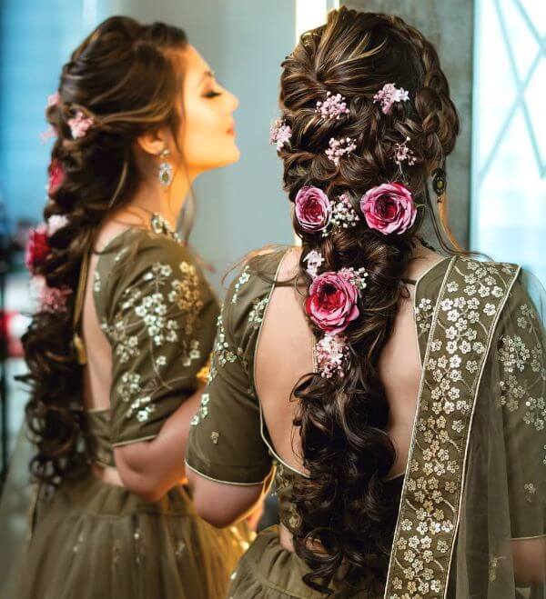 Curling up the hair anf form one braid, putting beautiful flower all over the hair for bridal look