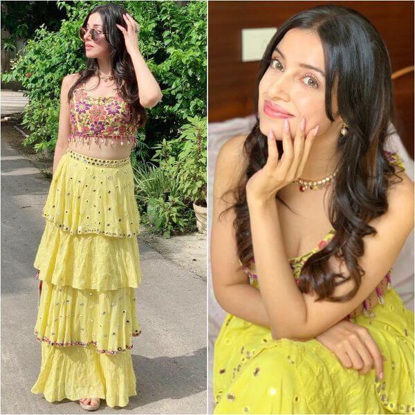 Divya Khosla donned a lemon yellow multi layered lehenga with multi color flower embroidered crop-top