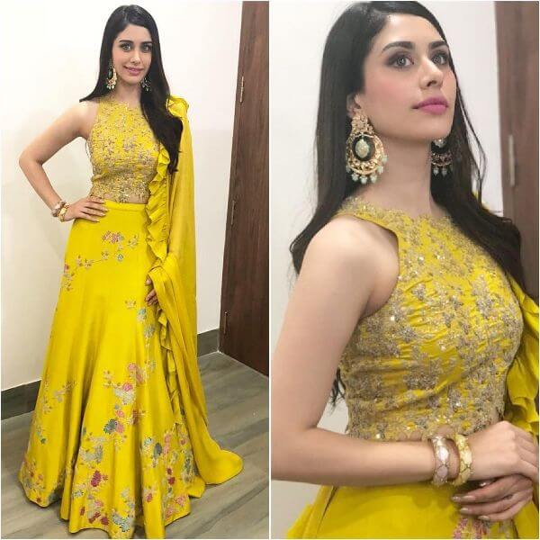 Warina Hussain in her yellow zero halter neck blouse and flower embroidered lehenga choli