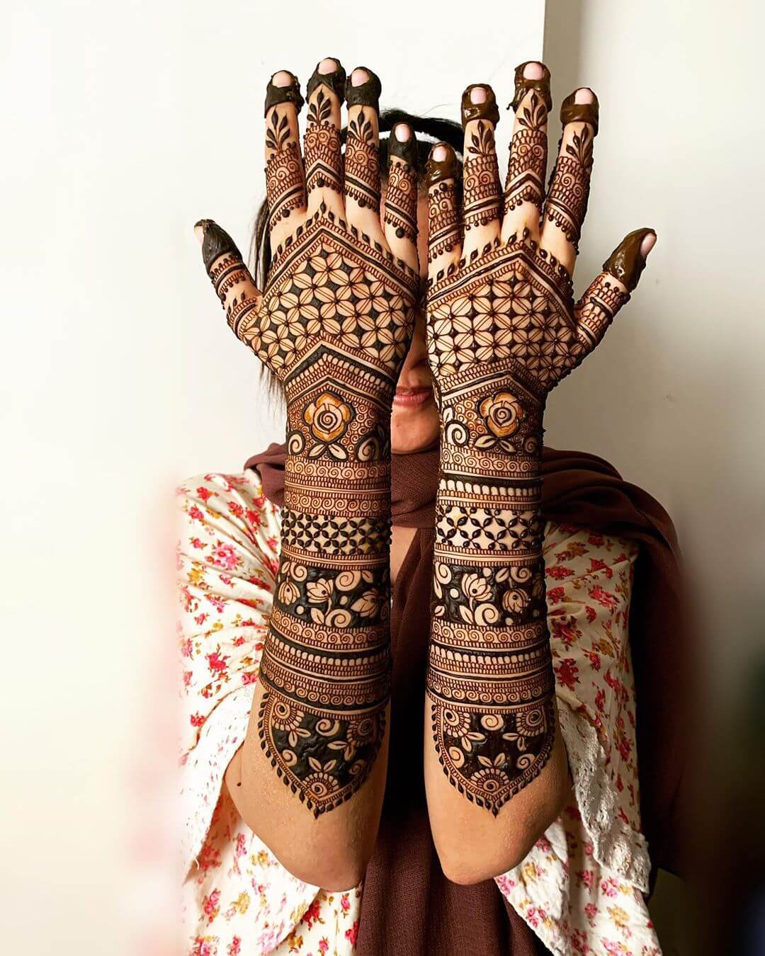 Designs for the bride's mehndi on the palms and backs of her hands.