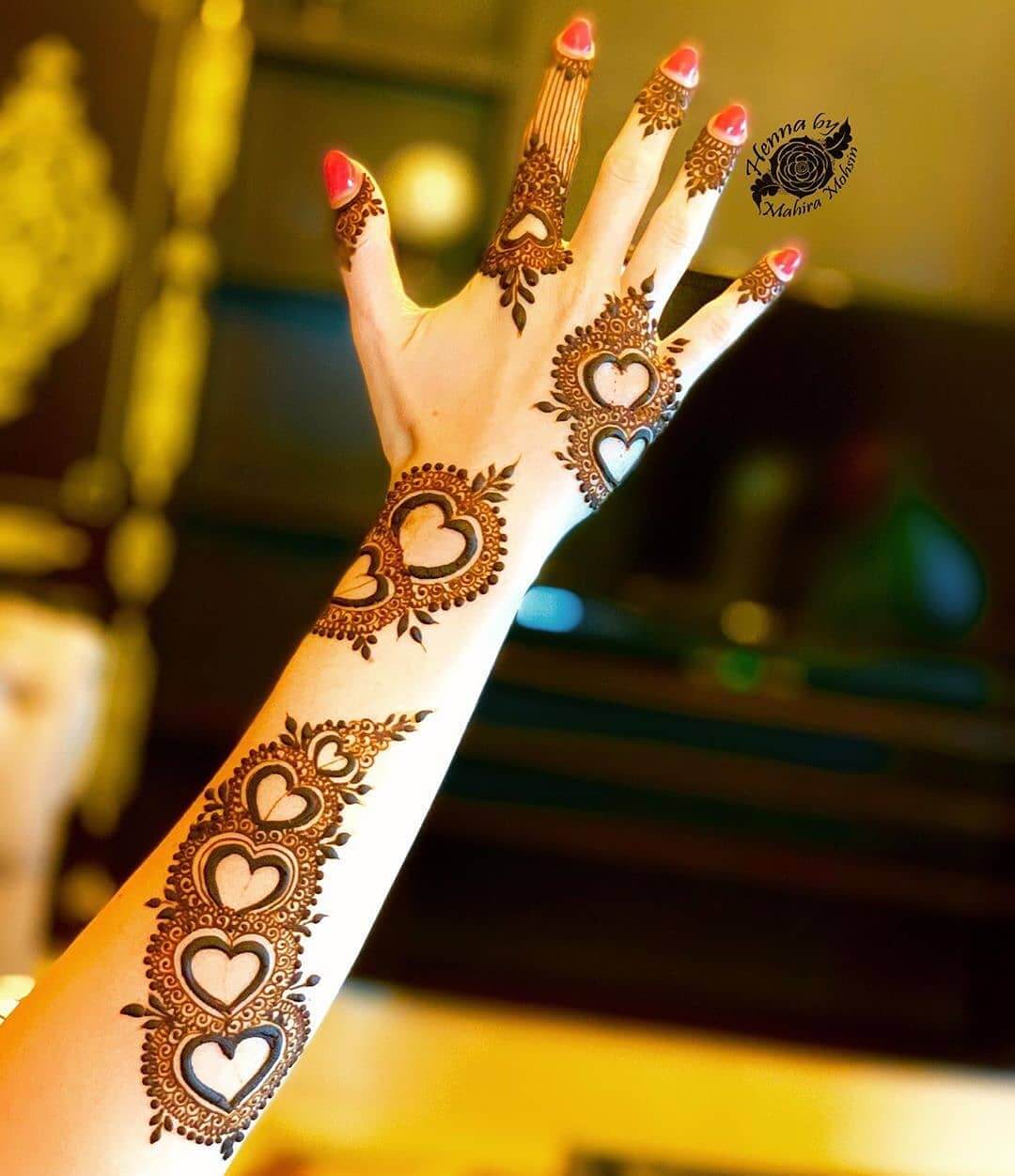 Delicate heart mehndi design for back of the palm