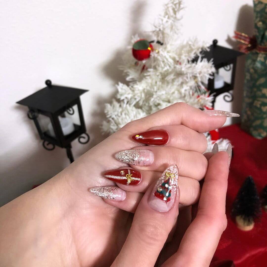 Glitter nail art with Christmas tree and ribbons
