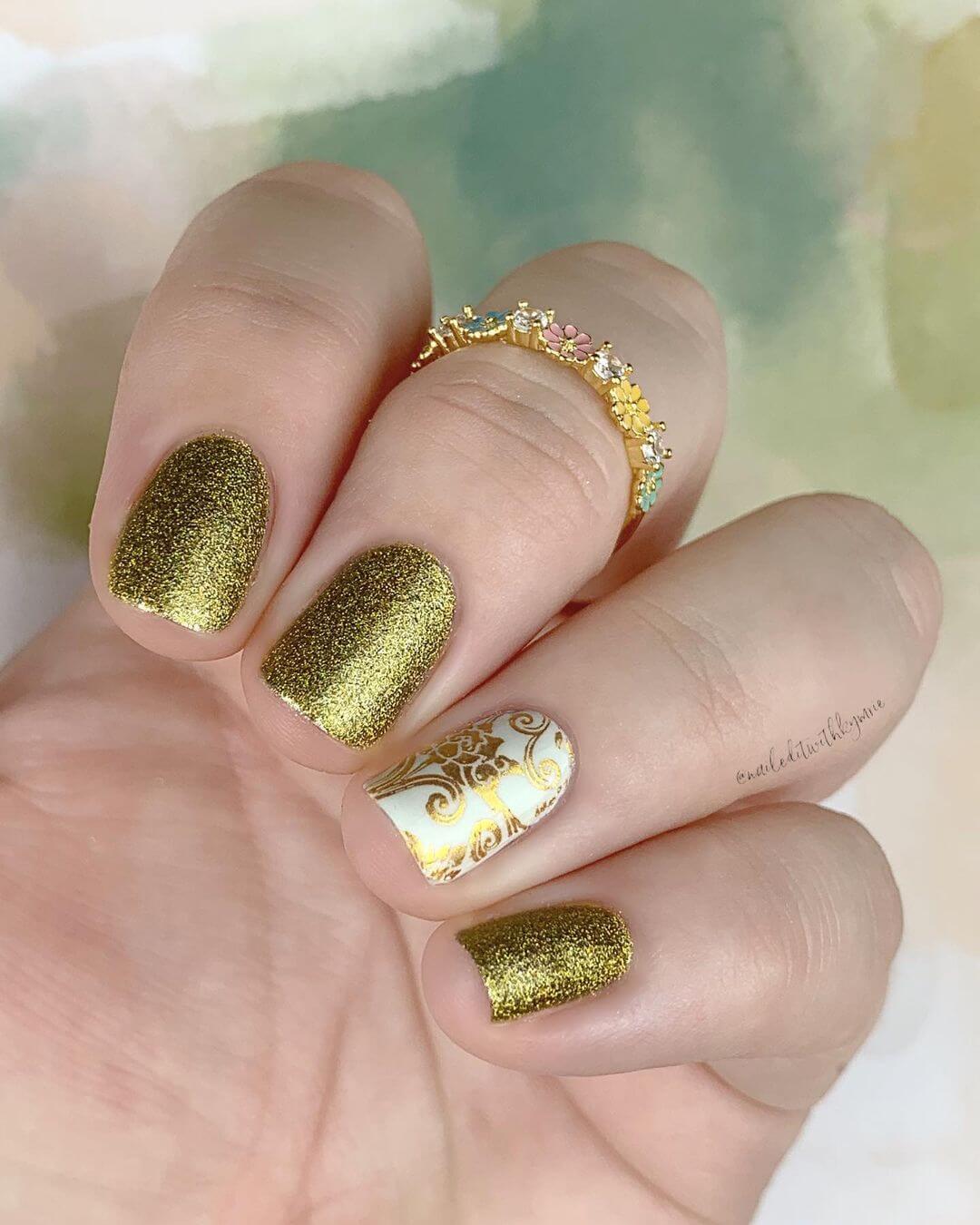 Gold Nail Art Designs Glittered gold with white pattern nail art design