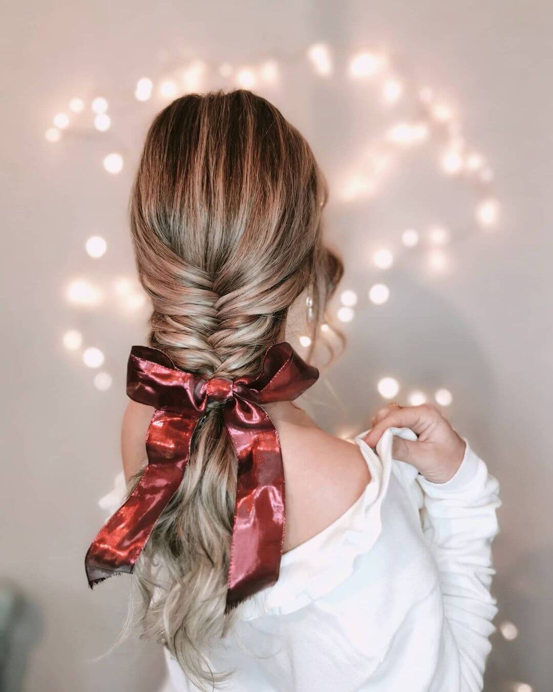 French braid with a long red ribbon