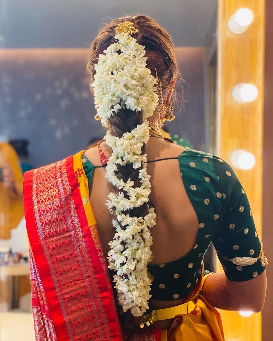Another voluminous gajra braided bridal hairstyle