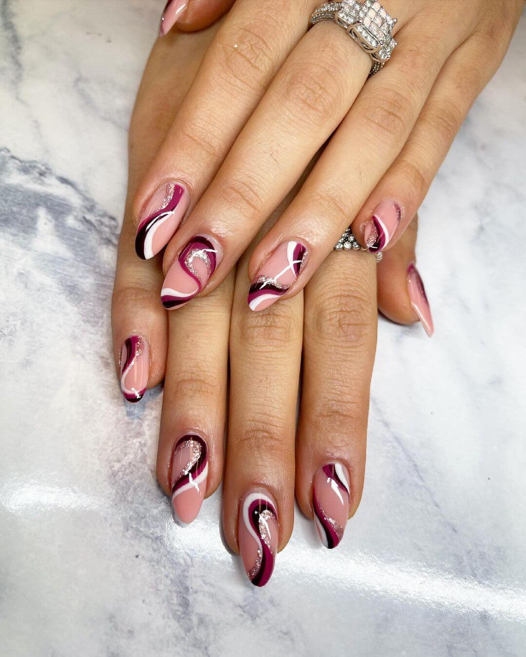 Wave patterns maroon nail art design