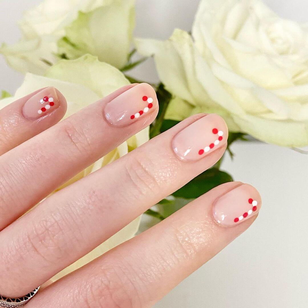 Minimalistic Dotted Candy Cane Nail Art Candy Cane Nail Art Designs for the Christmas Season