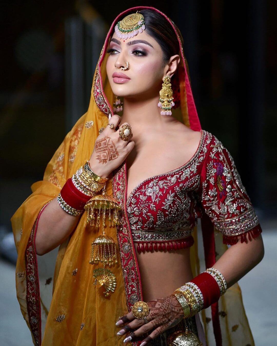 Akanksha Puri Is Looking Like a Beautiful Indian Bride In Red Blouse With Mustard Yellow Dupatta And Chuda