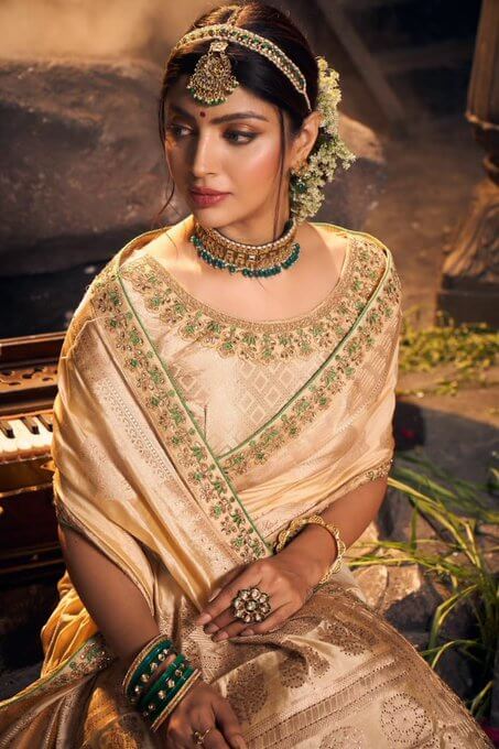 Bollywood Actress Akansha Puri Wearing Cream Colored Embroidery Saree With A Scoop Neck Blouse