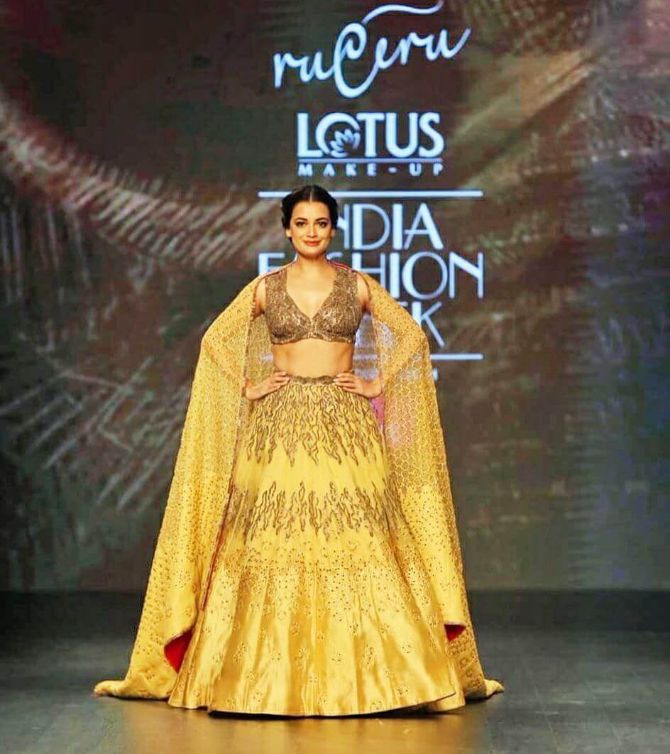 Dia Mirza walks the ramp at Delhi Fashion Week in Yellow Lehenga Set With Bown Sequin Detailing