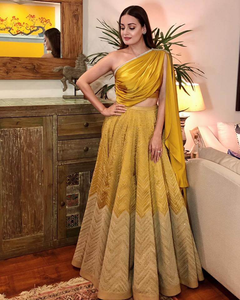  For Isha Ambani’s wedding reception Dia Mirza wore a yellow lehenga set with draped one-shoulder blouse