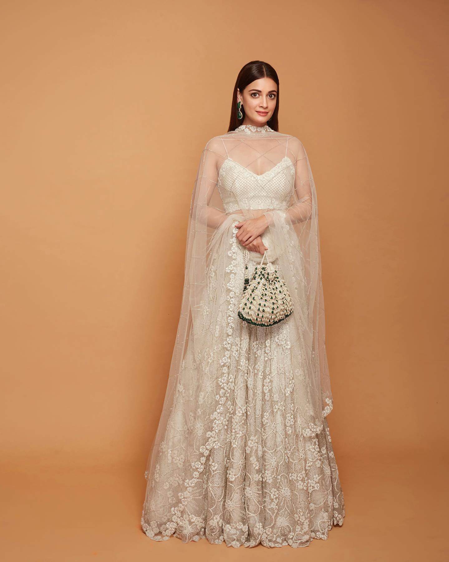 The actress made all heads turn in an Elegant White lehenga set with a statement potli bag and sheer dupatta