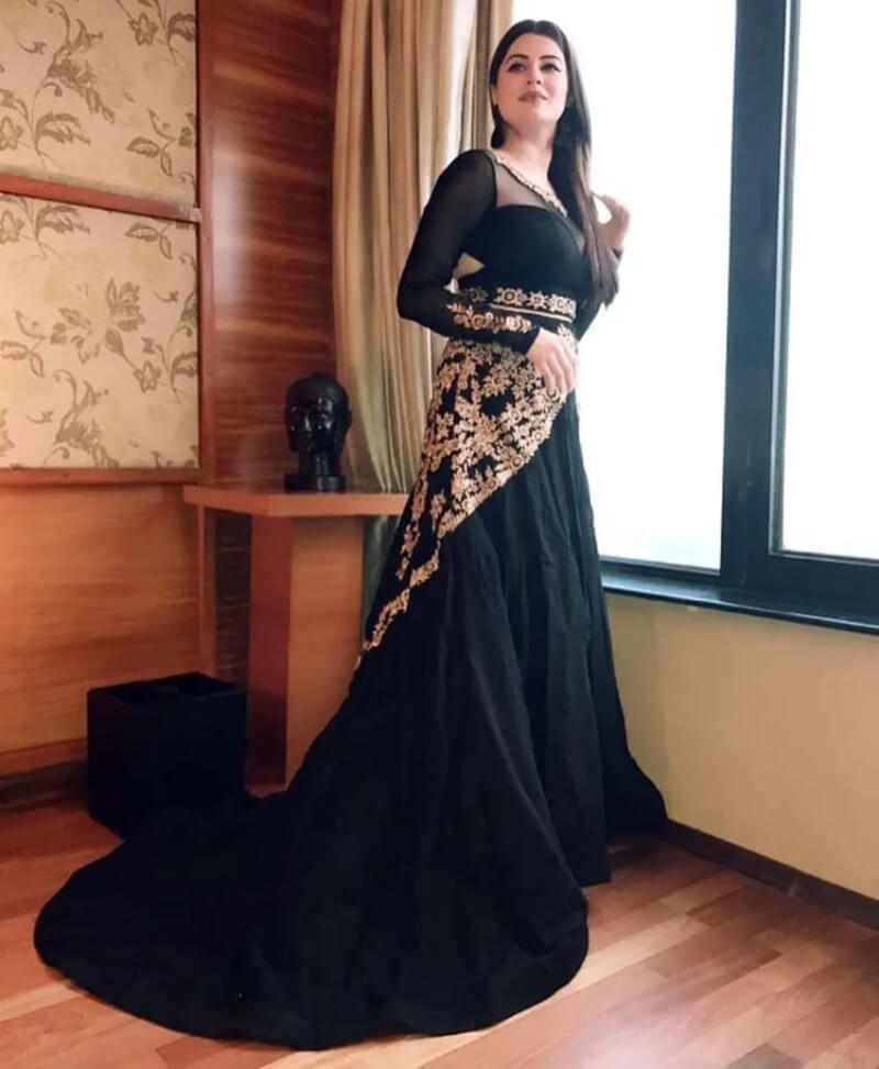 Bollywood Actress In black floor, length cut out gown with golden details