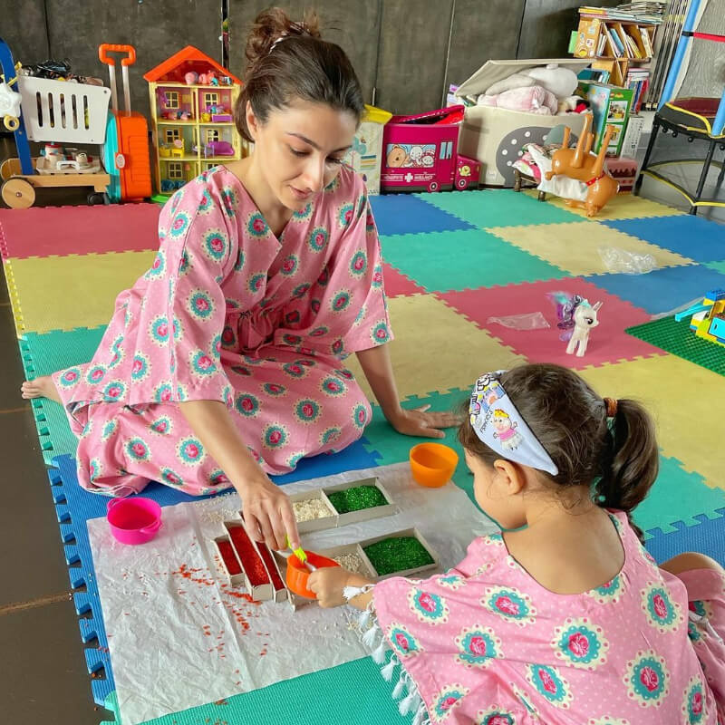 Bollywood Actress Soha Ali Khan plays with her daughter in their matching pink kaftans