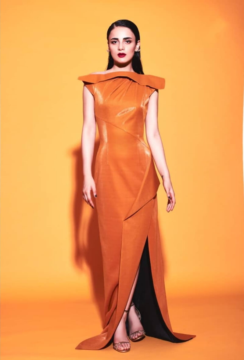 Radhika Madan in flaming orange gown with sharp cuts