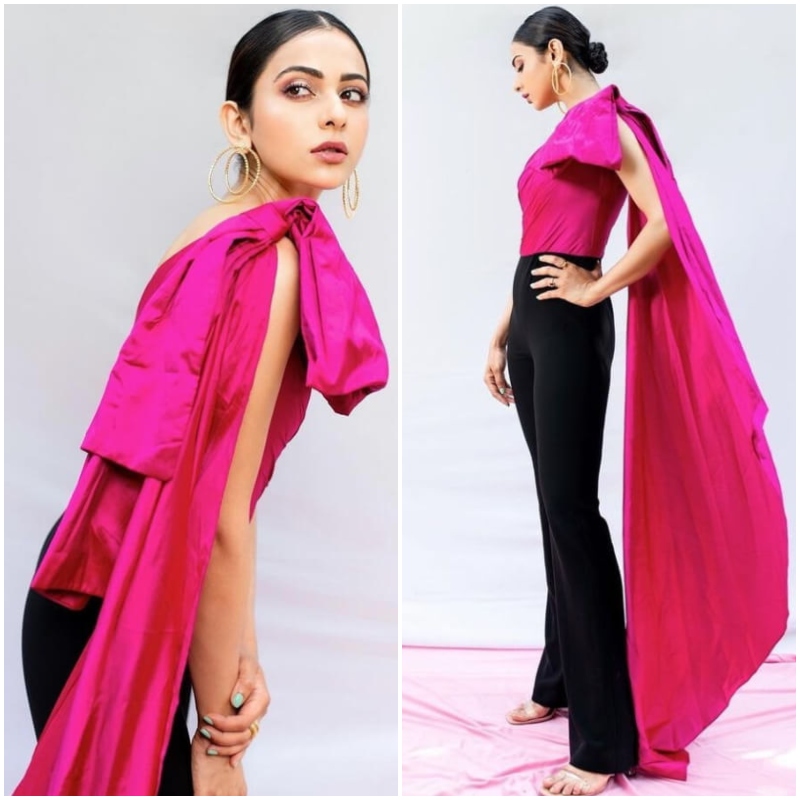 Rakul Preet Singh in black pants and a pink top with a massive bow