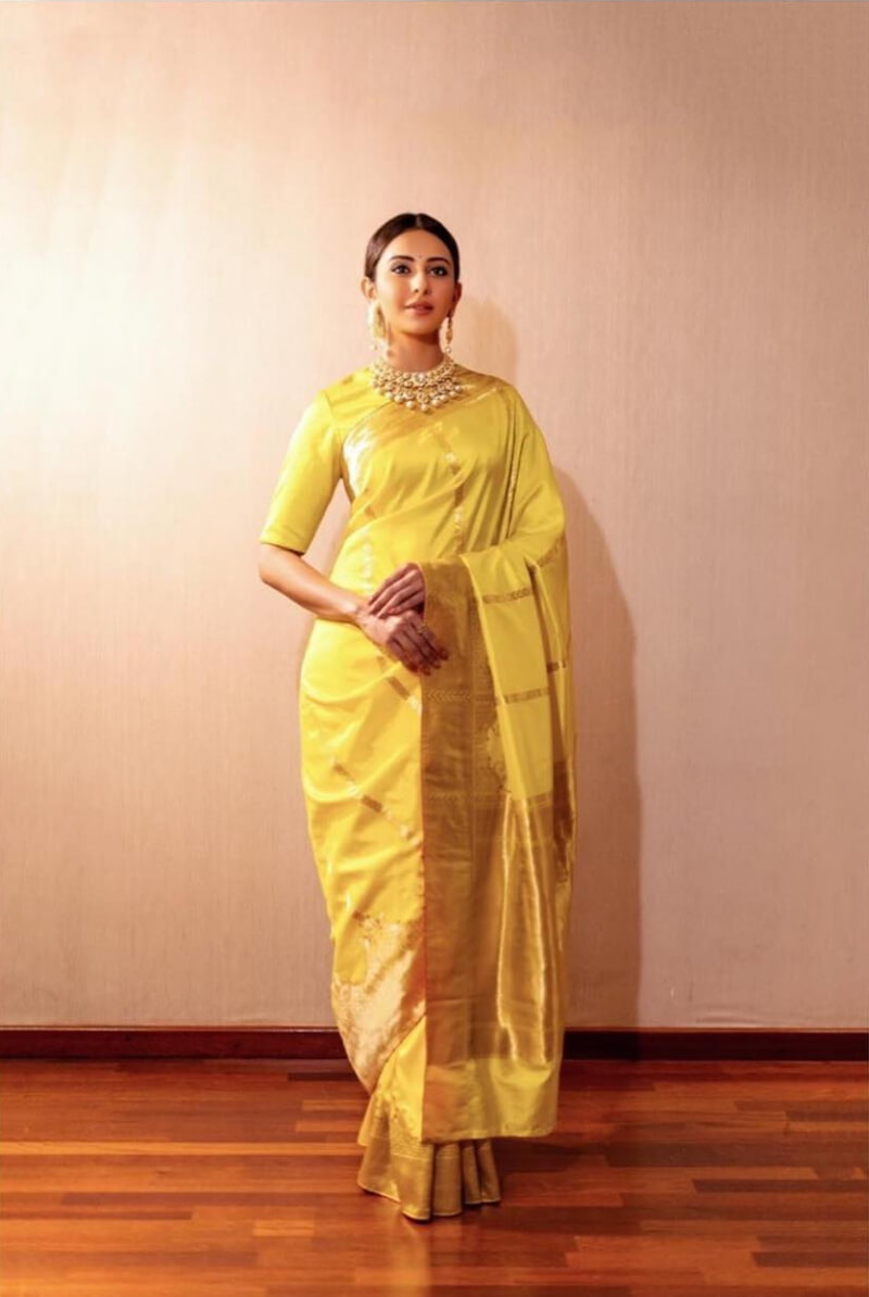 Rakul Preet Singh in bright yellow silk saree with matching blouse