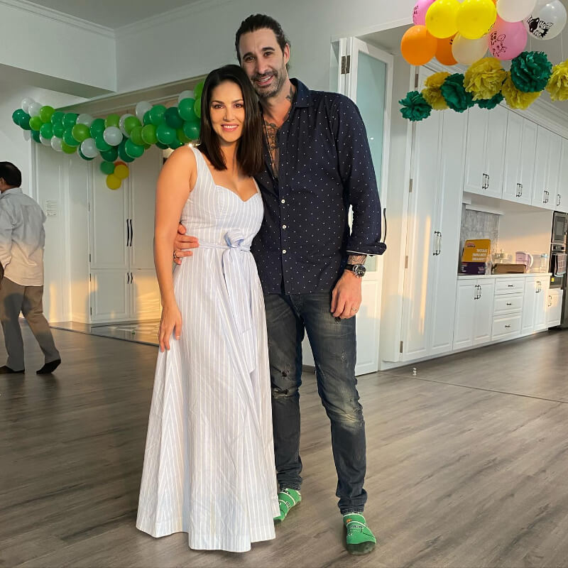 Sunny Leone and Daniel Weber in a blue and white striped dress with a polka dot shirt and denim
