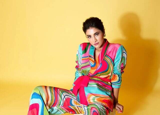 A Suave And Sophisticated Multicolored Pantsuit With A Pink Bow
