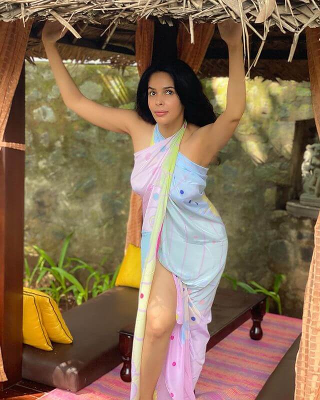 Dancer, Model, and Actress Mallika Sherawat in a multicolored beachwear
