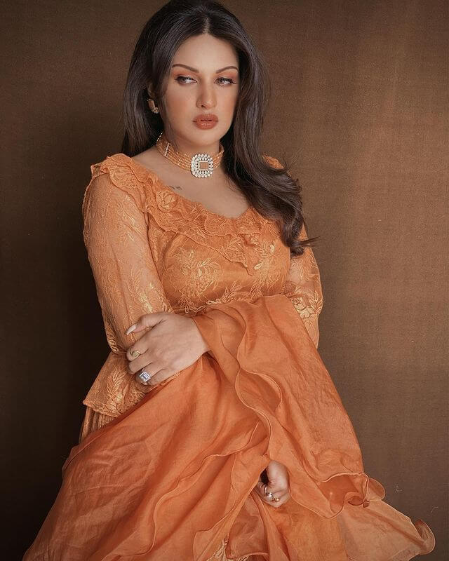 Punjabi Singer Himanshi Khurana In An Orange Outfit With A Choker