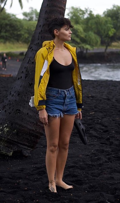 Brianna Hilderbrand's Beach Side Outfit In Black Top And Orange Jacket With Blue Denim Shorts 