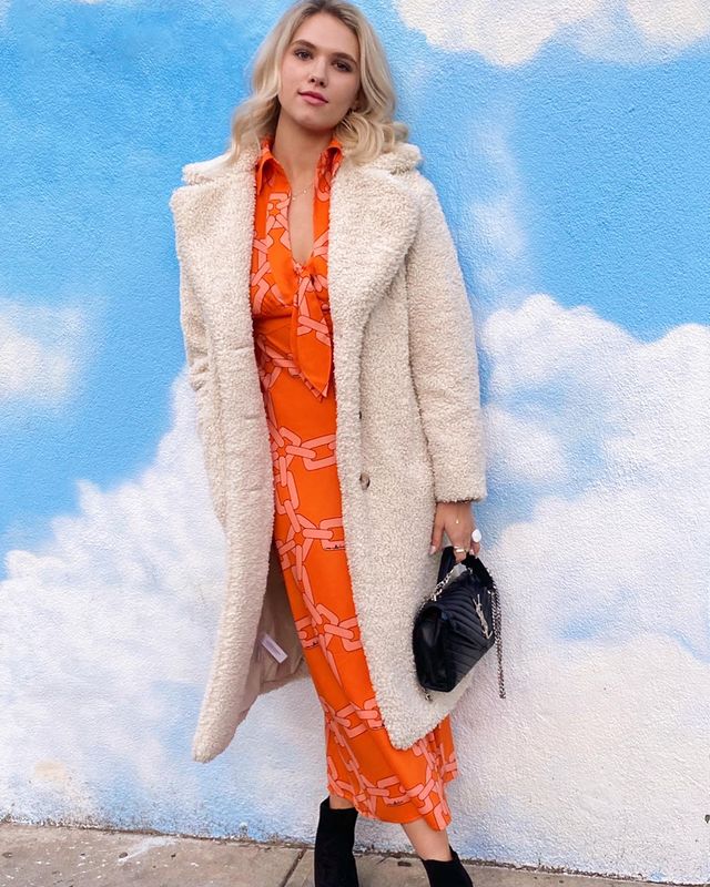 Claudie Looks Bright In An Orange Midi Skirt And An Overcoat