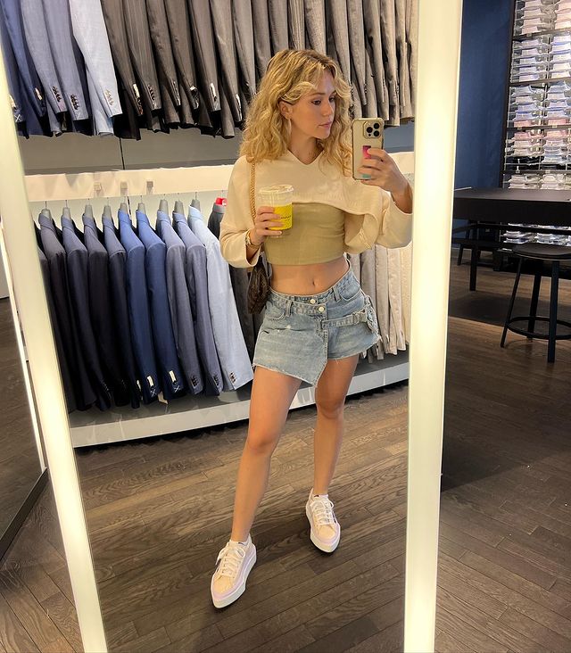 Coffee Is Must, Brec Bassinger In Dark Cream Colored Tank Top Topped With Creamy Half Top And Designer Denim Shorts