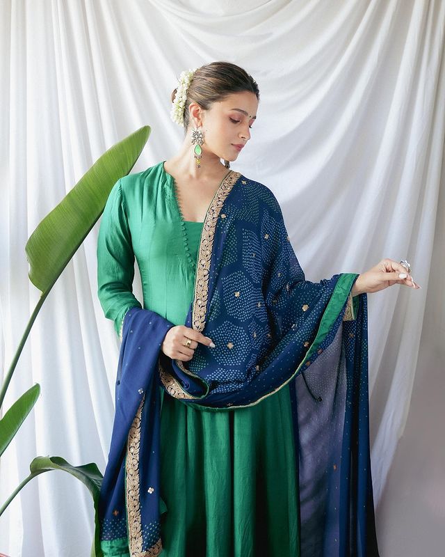 The Diva Is Catching Everyone's Eye In Green Colored Suit With Blue Color Printed Chunni Embellished With Gajra