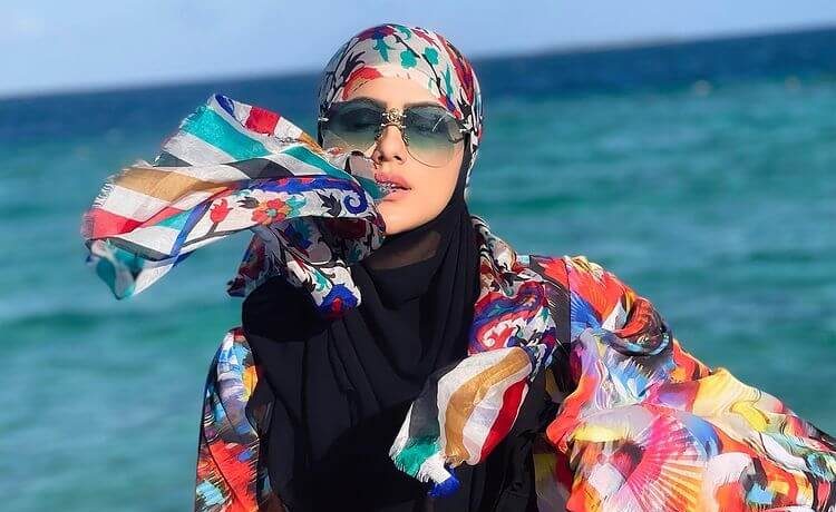 Sana Khan Wearing Multicolor Printed Abaya With A Black Scarf