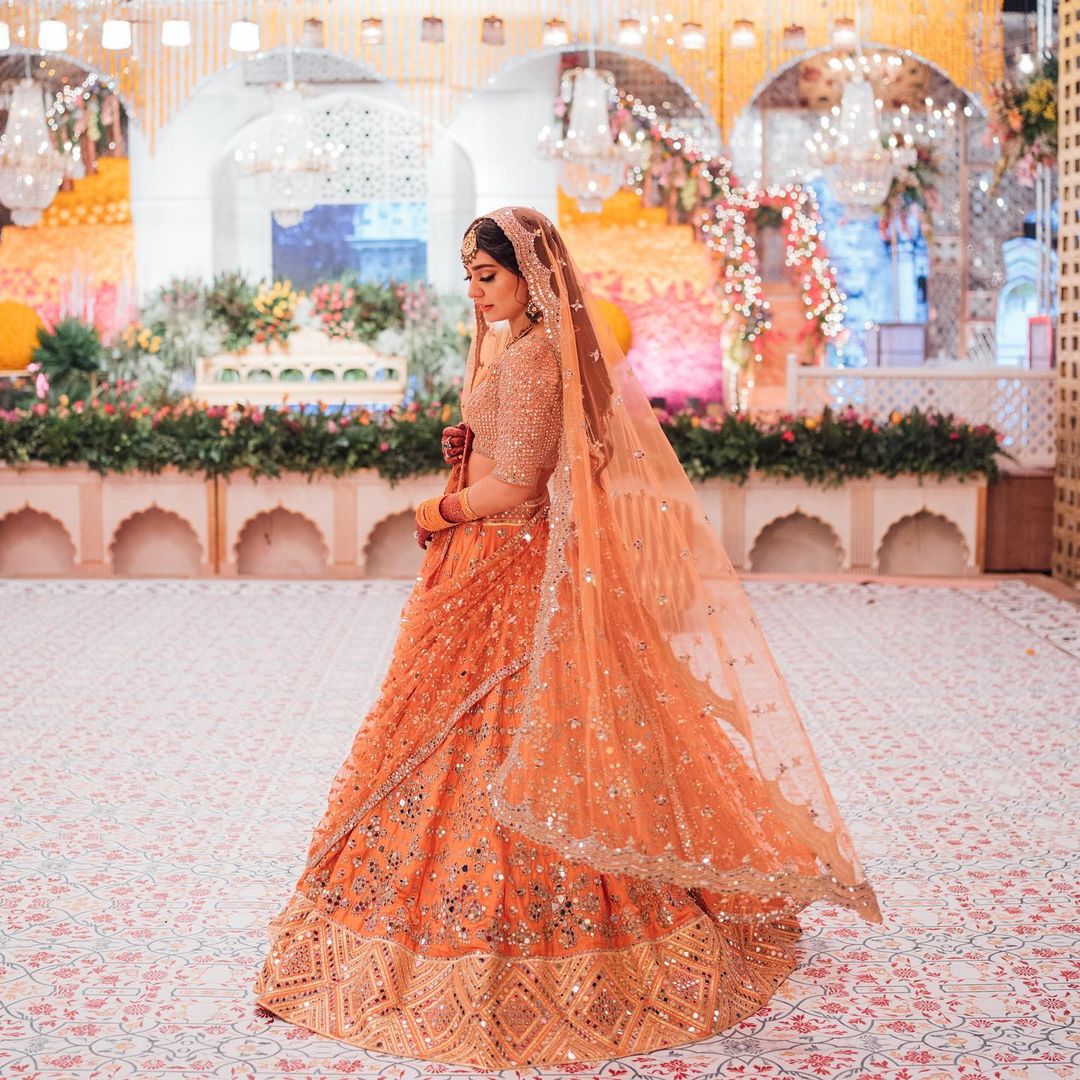 A Peach-Orange- Hued Lehenga Of A Stunning Bride