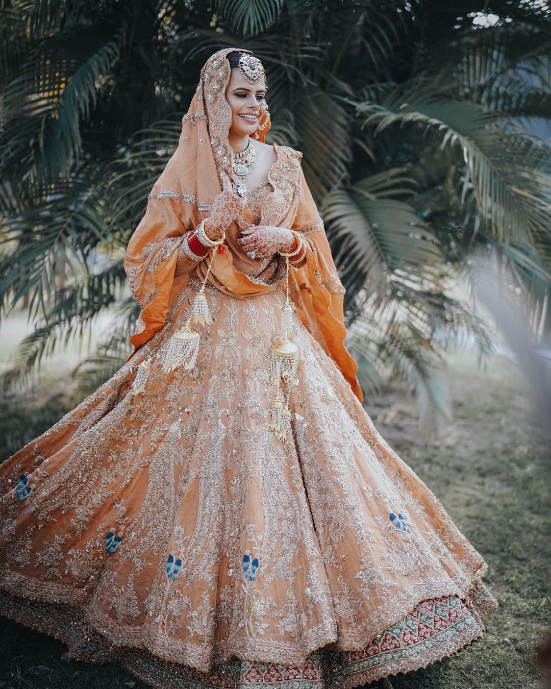 A Stunning Bride In Peach Orange Flora And Fauna Lehenga