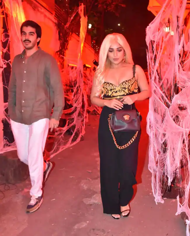 Bhumi Pednekar In A Golden Corset Top With Black Flared Pants. She Was Wearing A Shiny Golden Wig