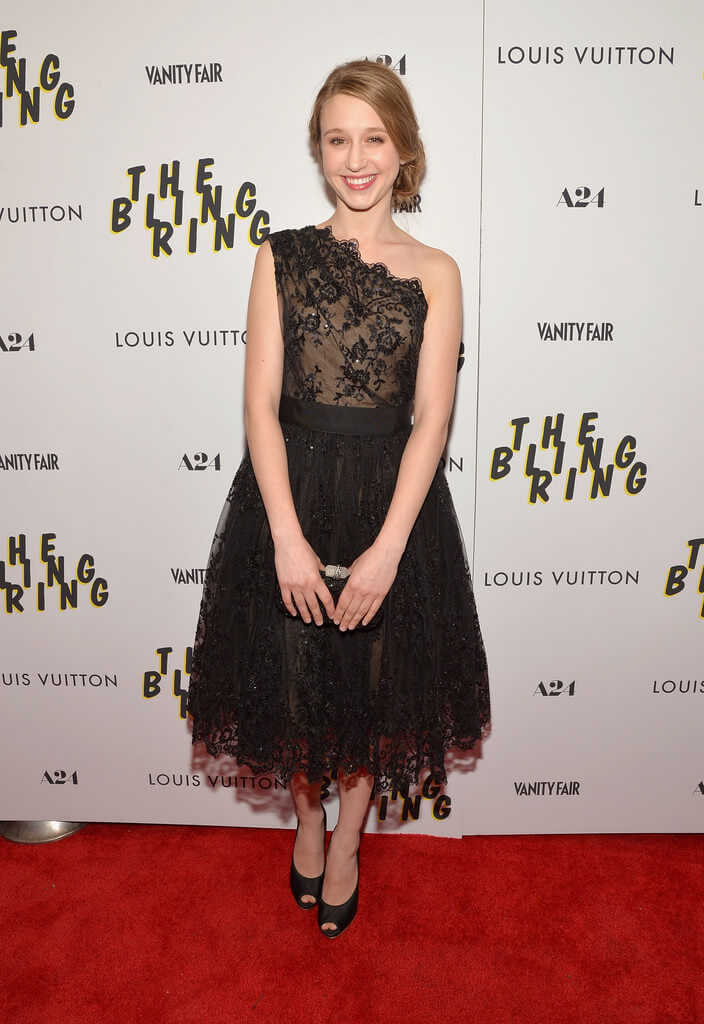 Taissa In A One-Shouldered Black Lace Frock