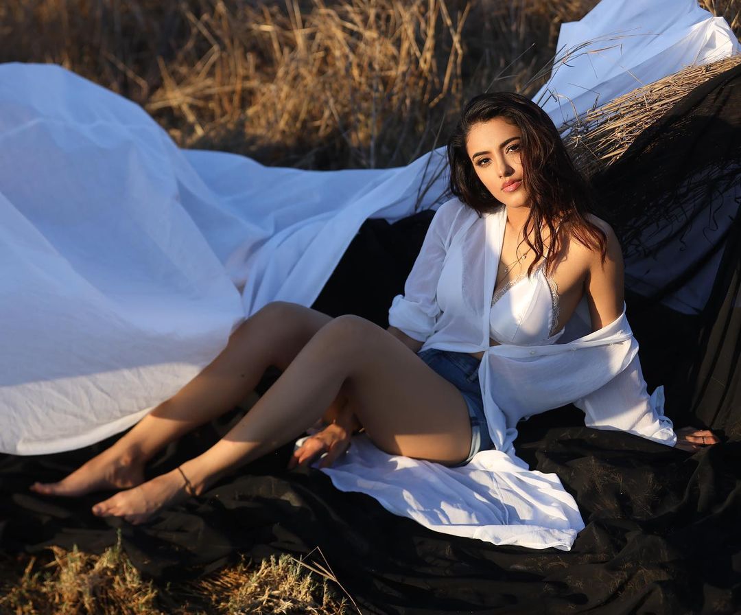 Malvika Sharma Gives Us Beachy Vibes In White Loose Shirt With Hot Pants Malvika Sharma Simple yet Stunning Outfit Looks