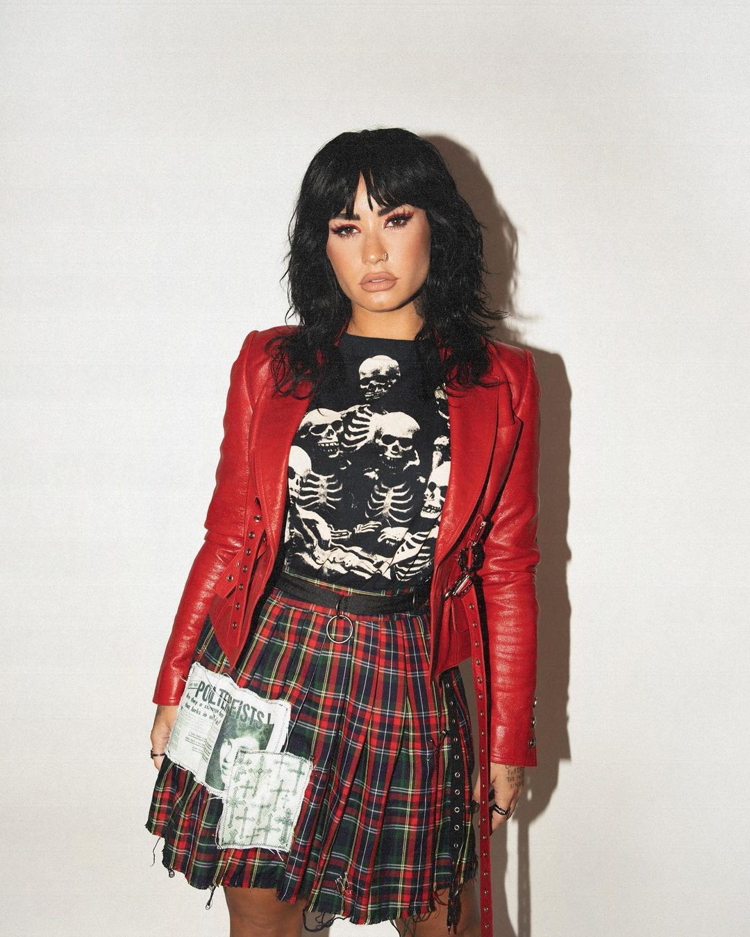 Sassy Demi In Printed Black Tee & Checkered Skirt Topped With Red Leather Jacket