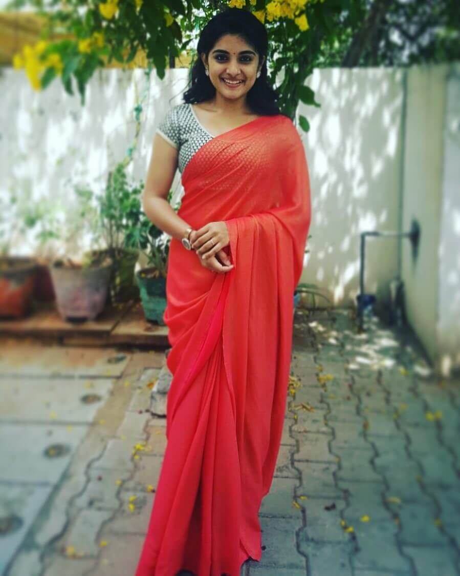 Nivetha Thomas Look Attractive In Plain Red Saree With a Silver Blouse Outfit