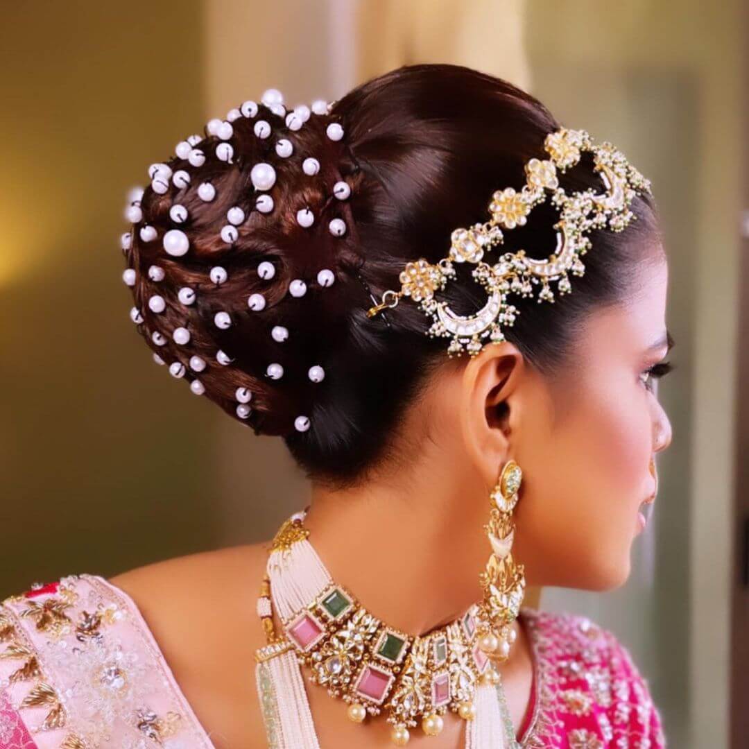 This Has A Different Shine To It Indian Bridal Bun Hairstyle With Pearl For Wedding